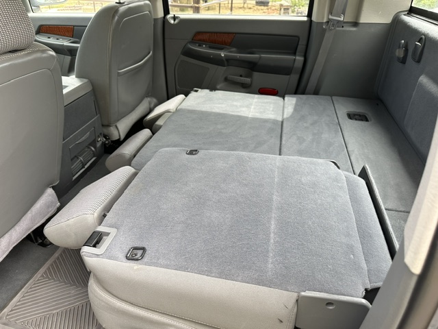 After interior detailing: clean folded rear seats and cargo floor in a Dodge Durango