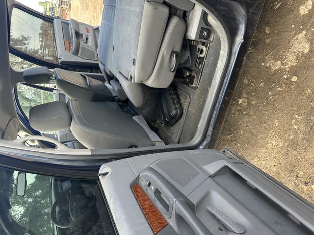 Before interior detailing: dirt-covered rear footwell and door sill in a Dodge Durango