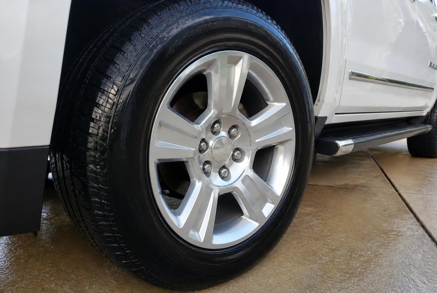 Clean alloy wheel and dressed tire on a detailed truck